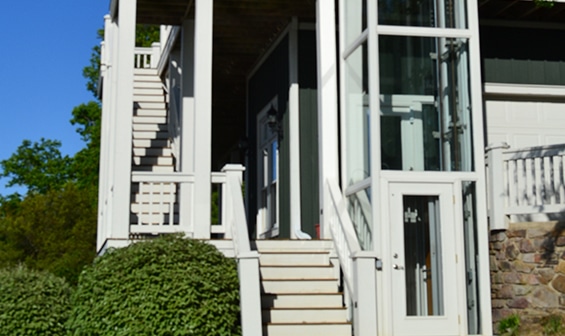 Outdoor pneumatic elevator next to patio staircase