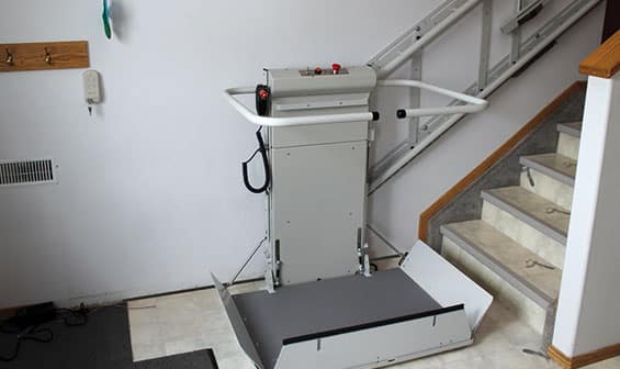 Inclined wheelchair lift at bottom of the stairs