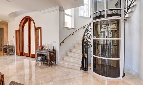 Pneumatic Vacuum Elevator next to a stairway in a luxury home