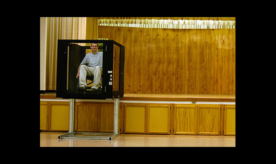 Man using Ascension Protege vertical wheelchair lift to exit a stage