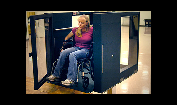 Handicapped woman using an Ascension Protege vertical wheelchair lift