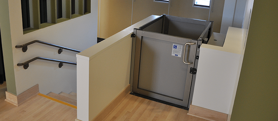 wheelchair lift installed in school next to stairs