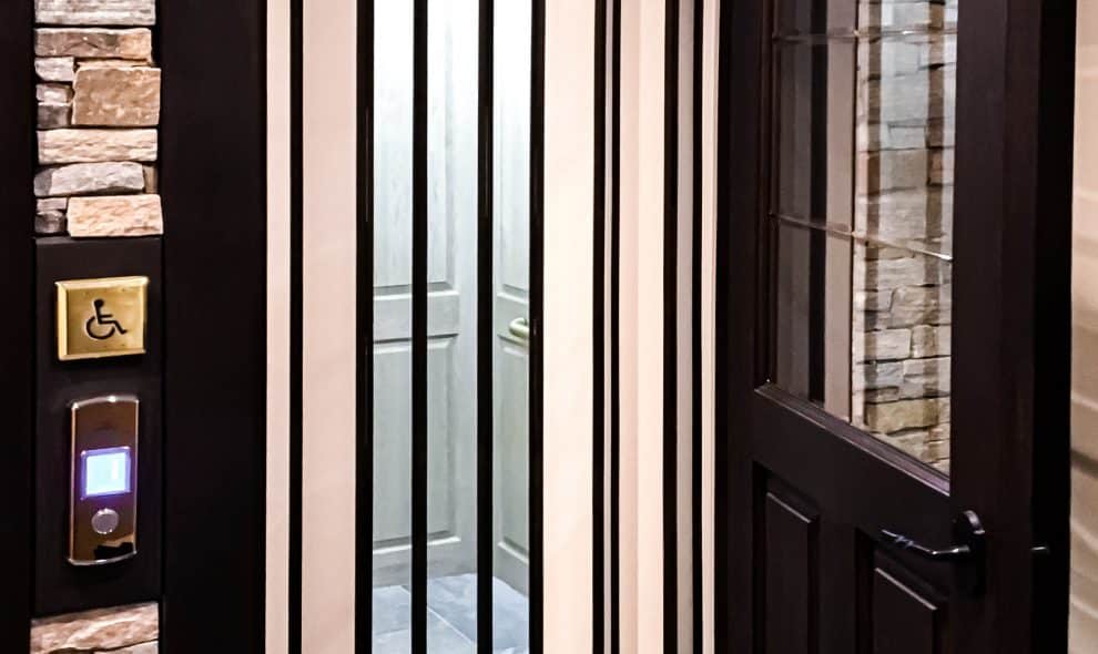 bifold glass elevator with stone surround