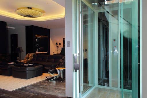 all glass paneled elevator in modern home