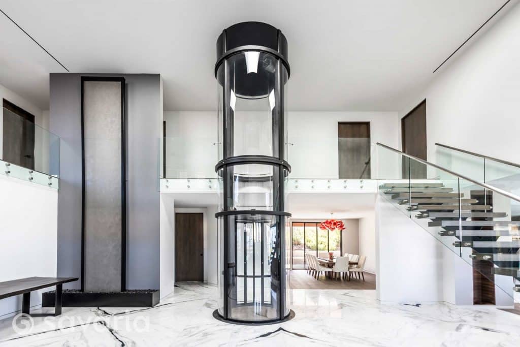 Round clear elevator in center of home entryway