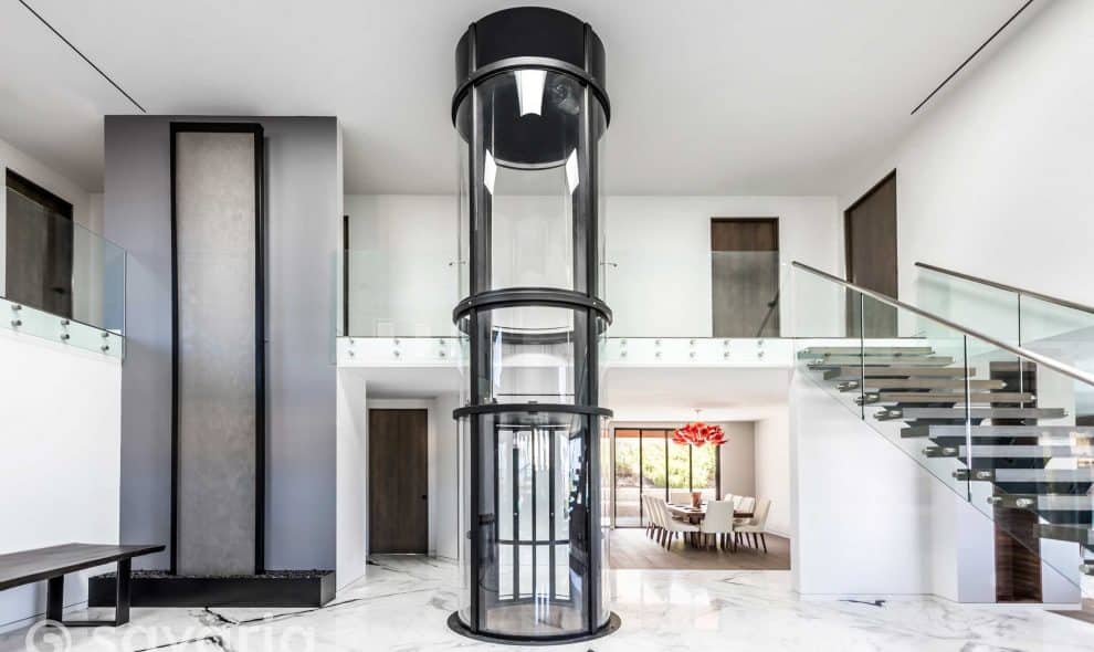 Round clear elevator in center of home entryway