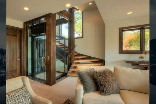 Glass elevator in luxury home from living area.