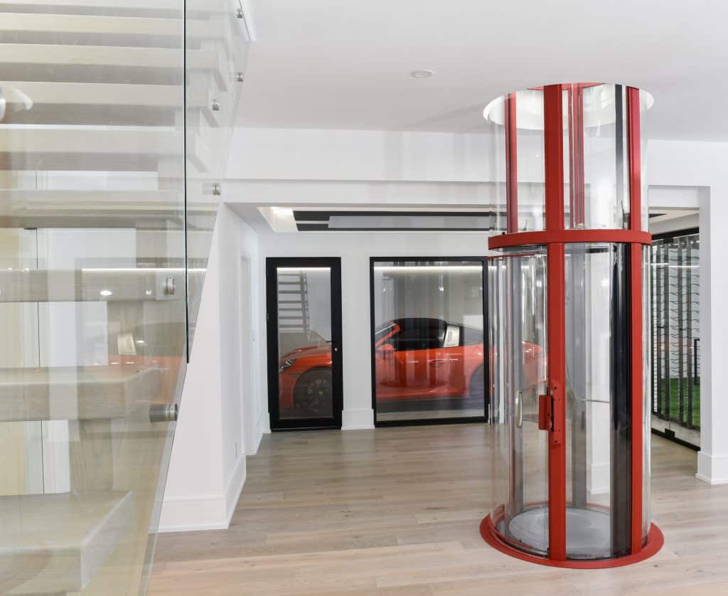 Round glass elevator with red trim